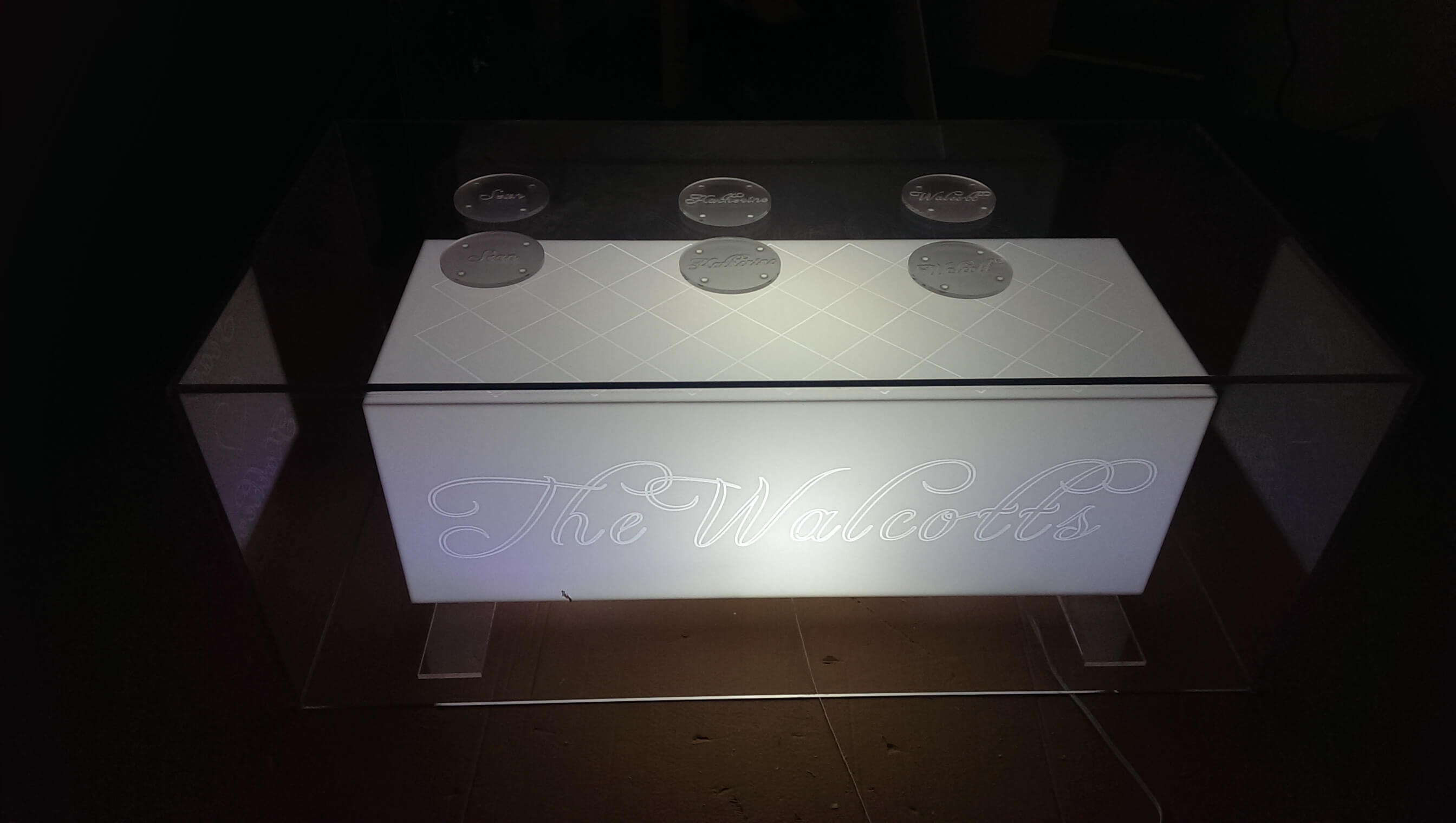Acrylic center table with engraved letters and lighting effects